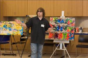 Artist John Bramblitt talks about his artwork during an Art Beyond Sight access program.