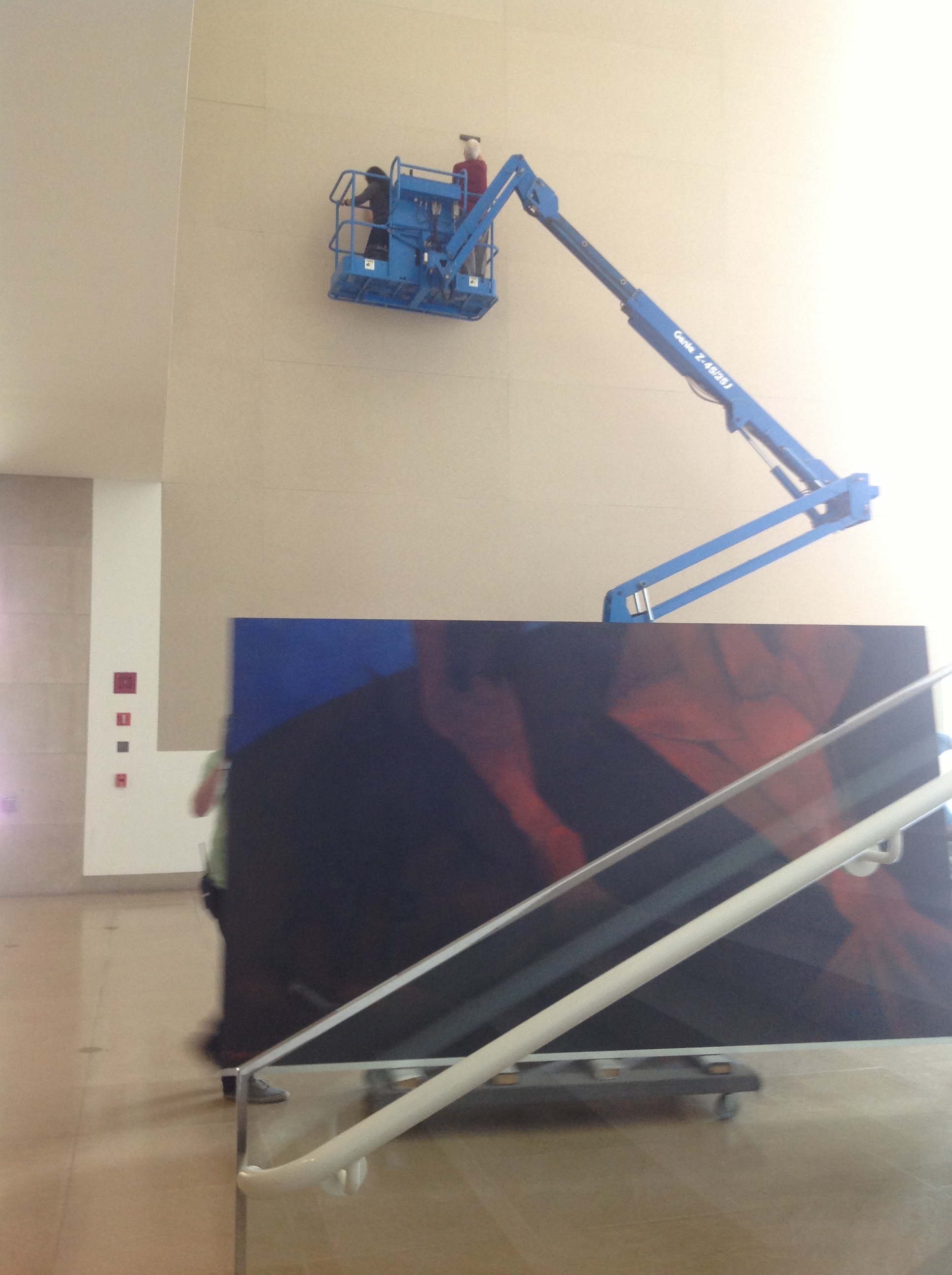 DMA staff vacuuming the Atrium wall in preparation for Tamayo’s painting. 