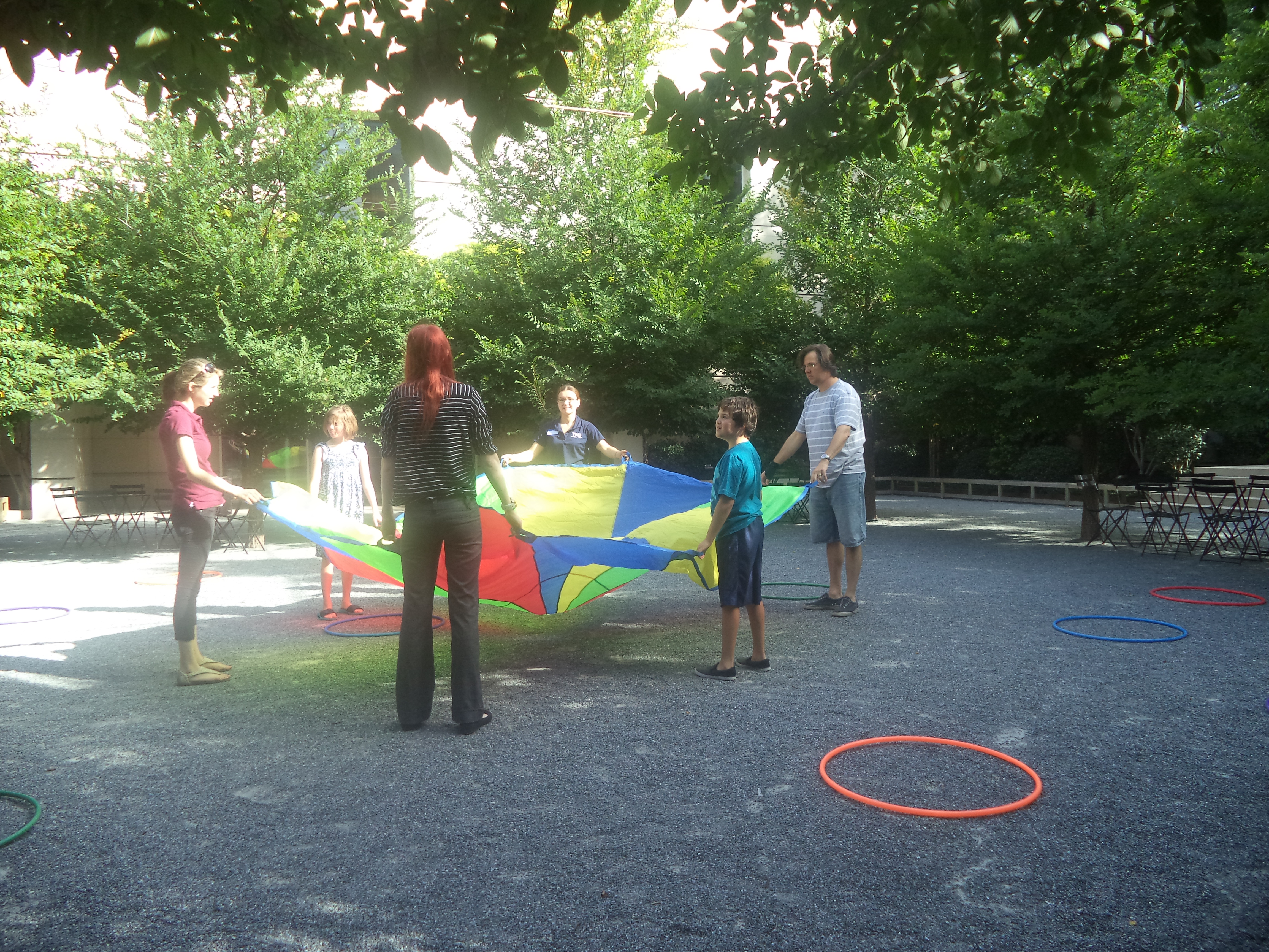 Play time with hula hoops, streamers, and parachutes in the courtyard