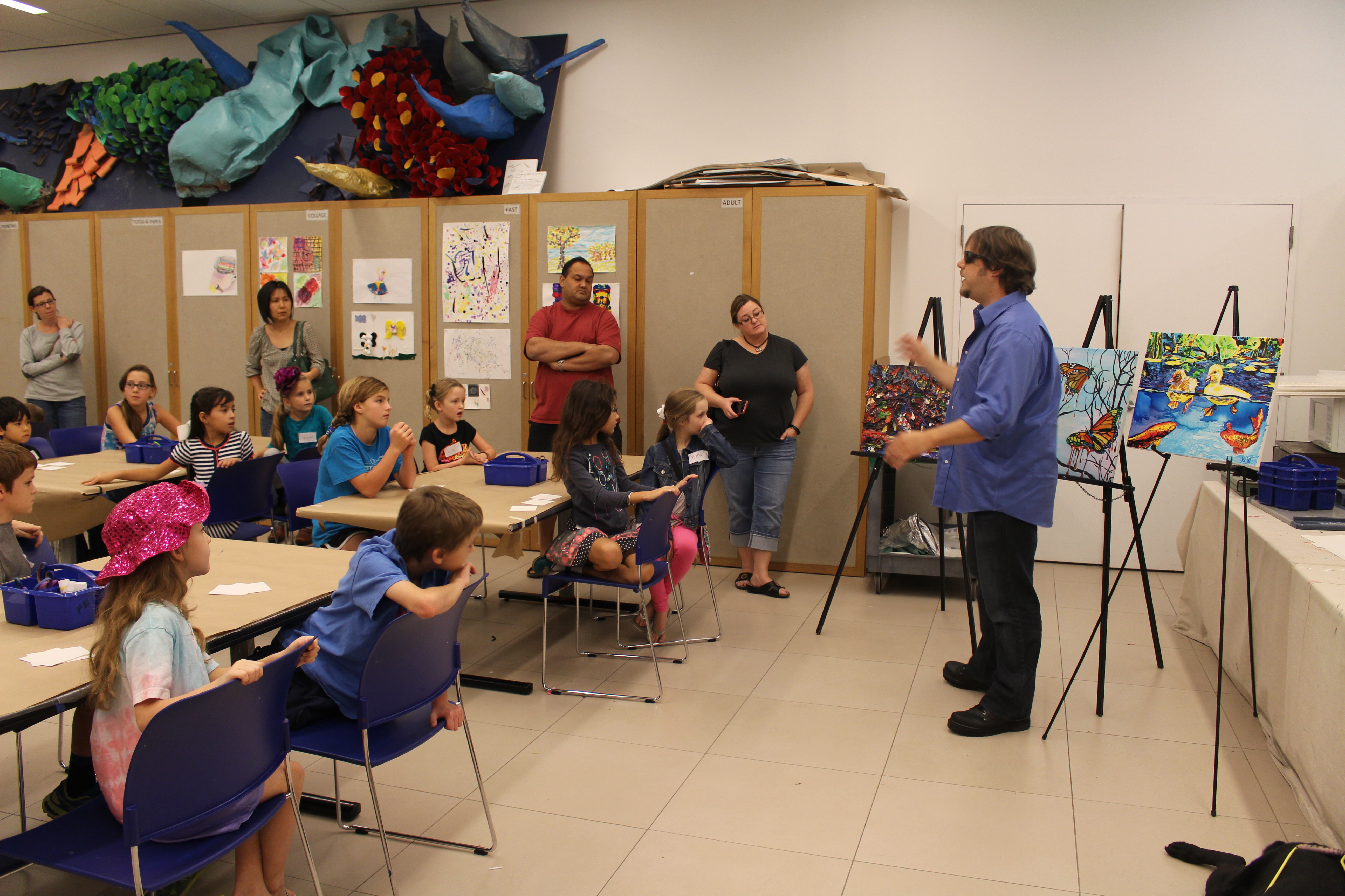 John Bramblitt talking about his artistic process with visitors in the studio.
