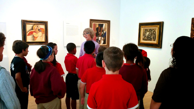 DMA Docent Carolyn Harris captivates a group of fourth graders during a school visit. 