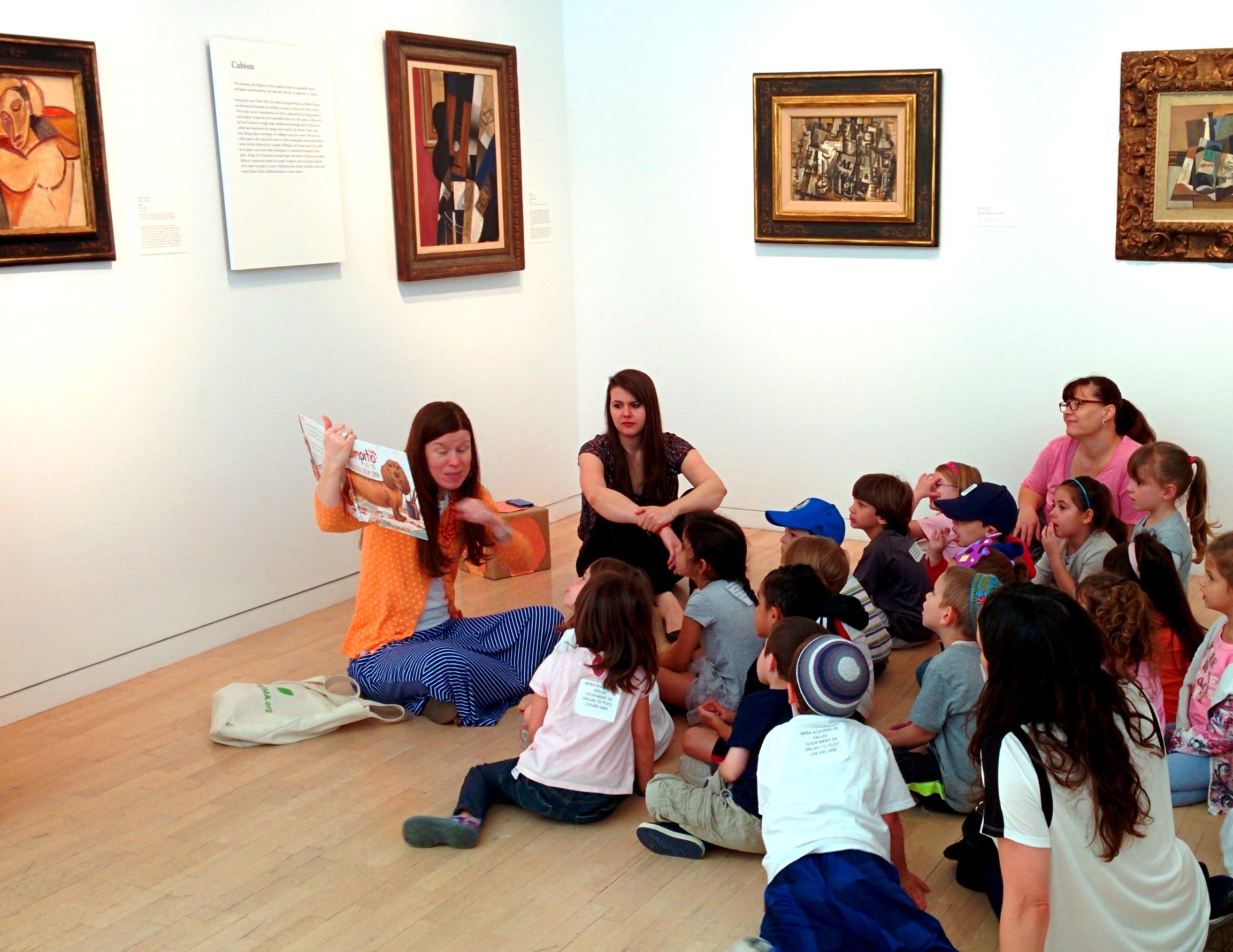 Leah Hanson, Manager of Early Learning Programs, reads a story to Pre-K children in the galleries.