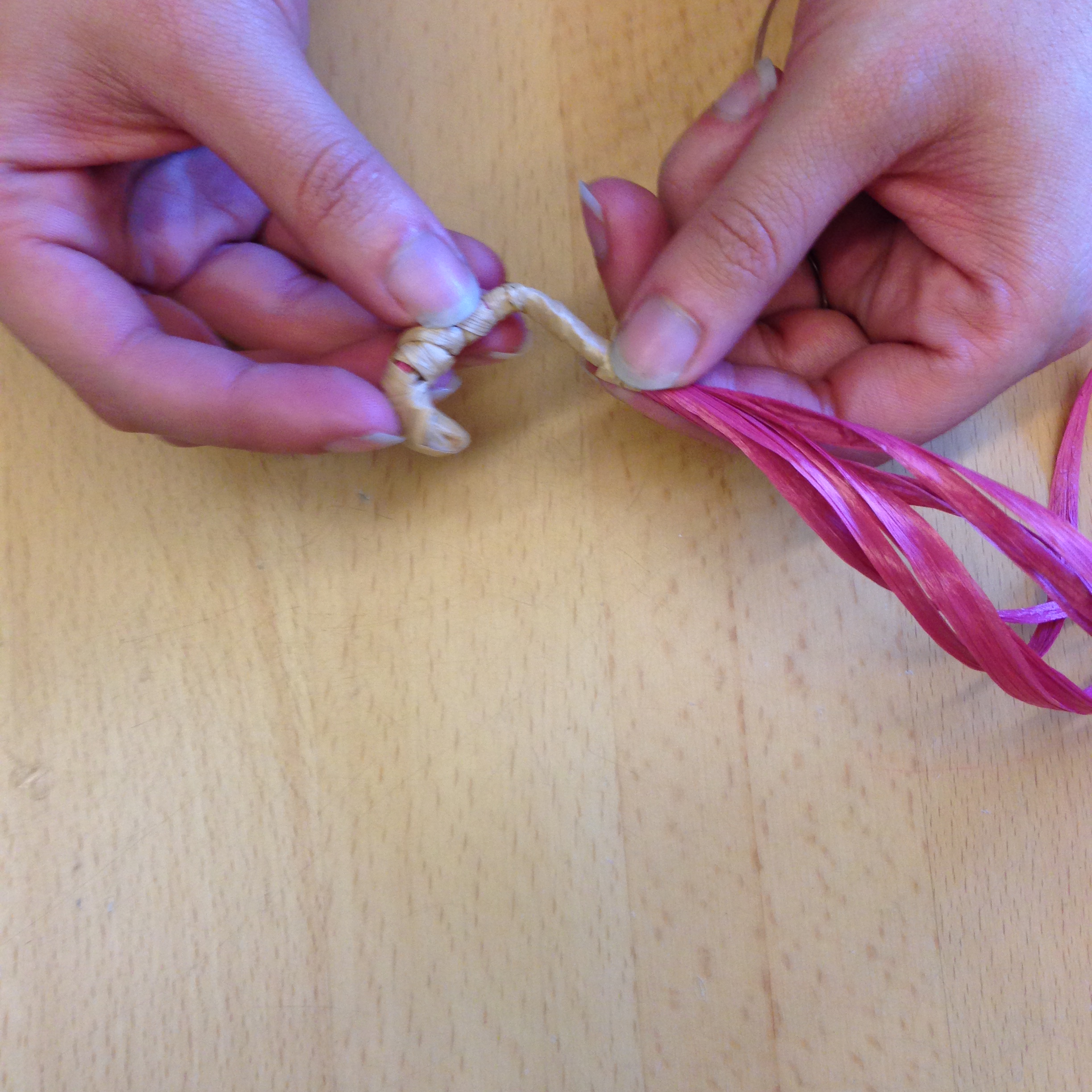 Cover about two inches of the red basket core, then begin spiral the wrapped end inward