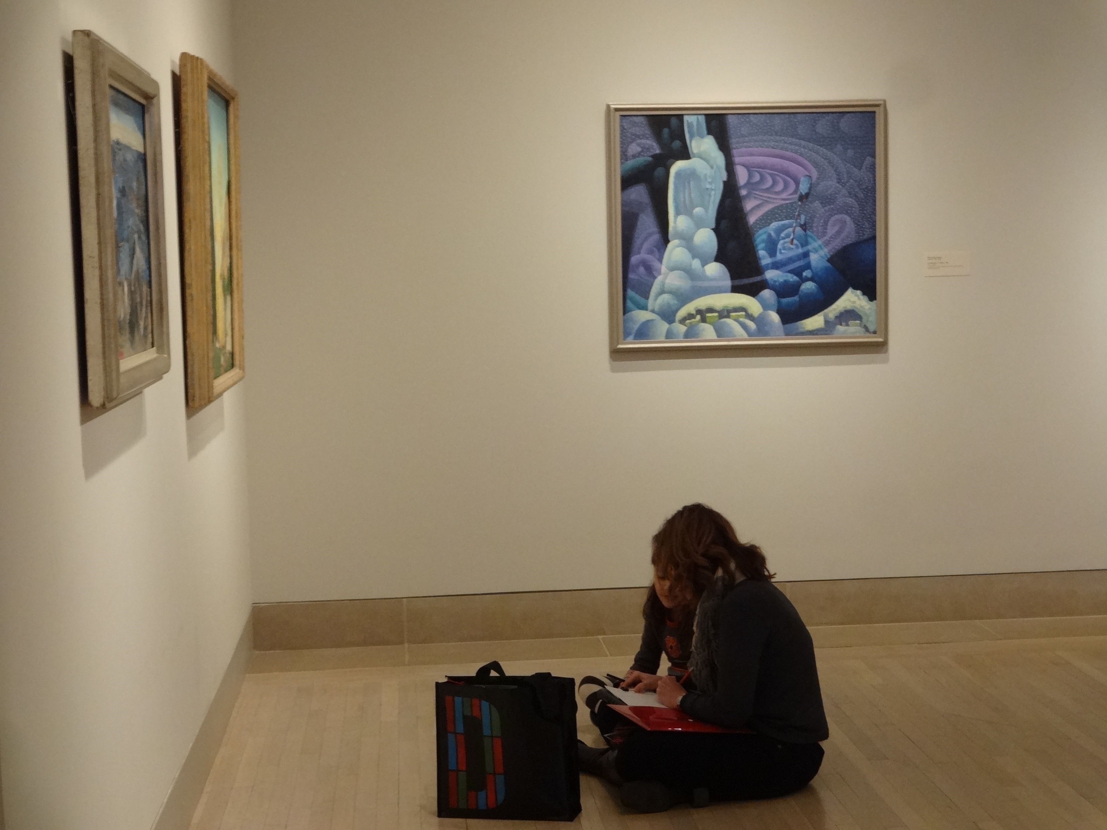 Family completing a writing activity in the American Art gallery.