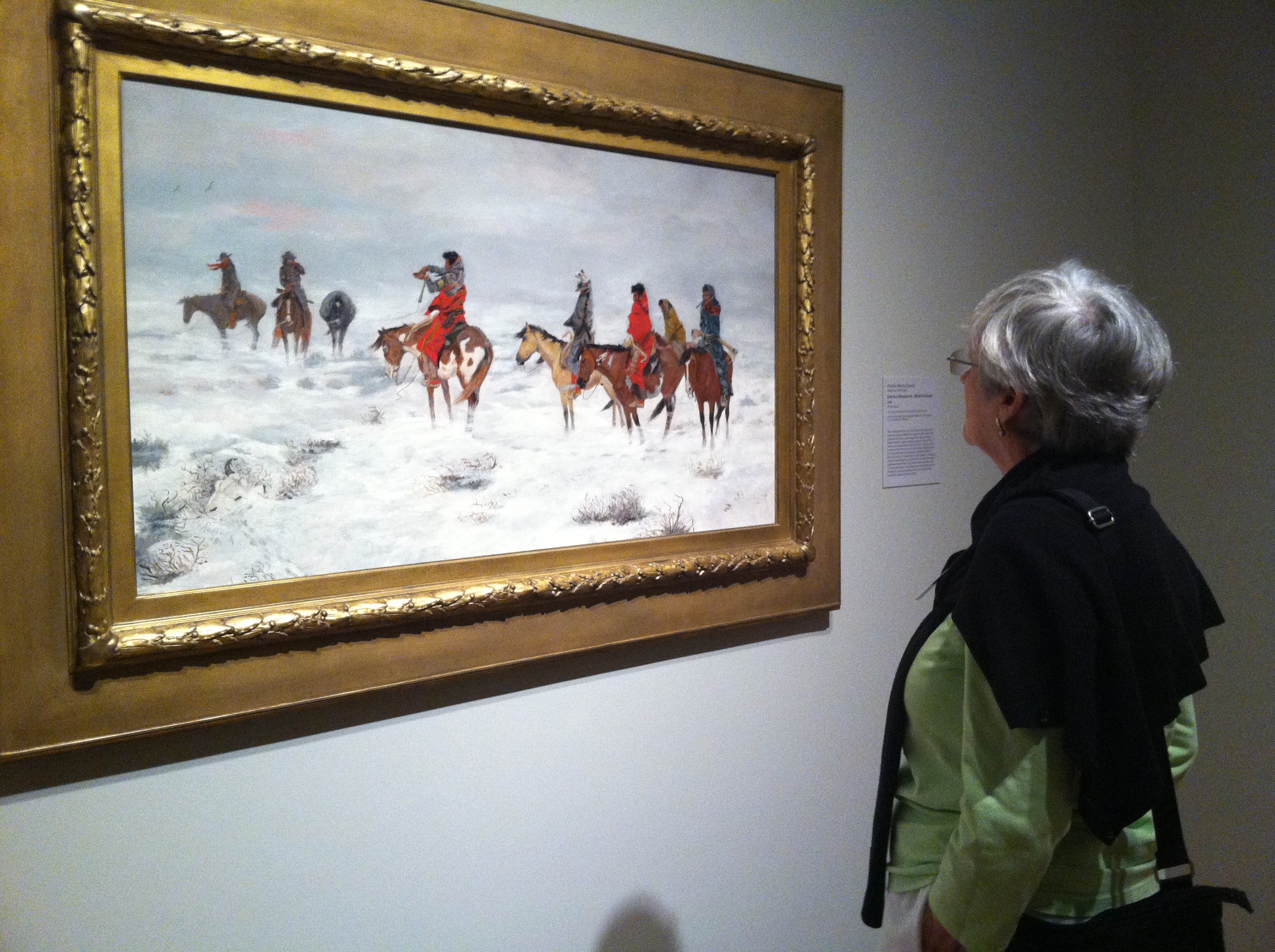 Docent Judy Butts examines Charles Marion Russell's Lost in a Snowstorm