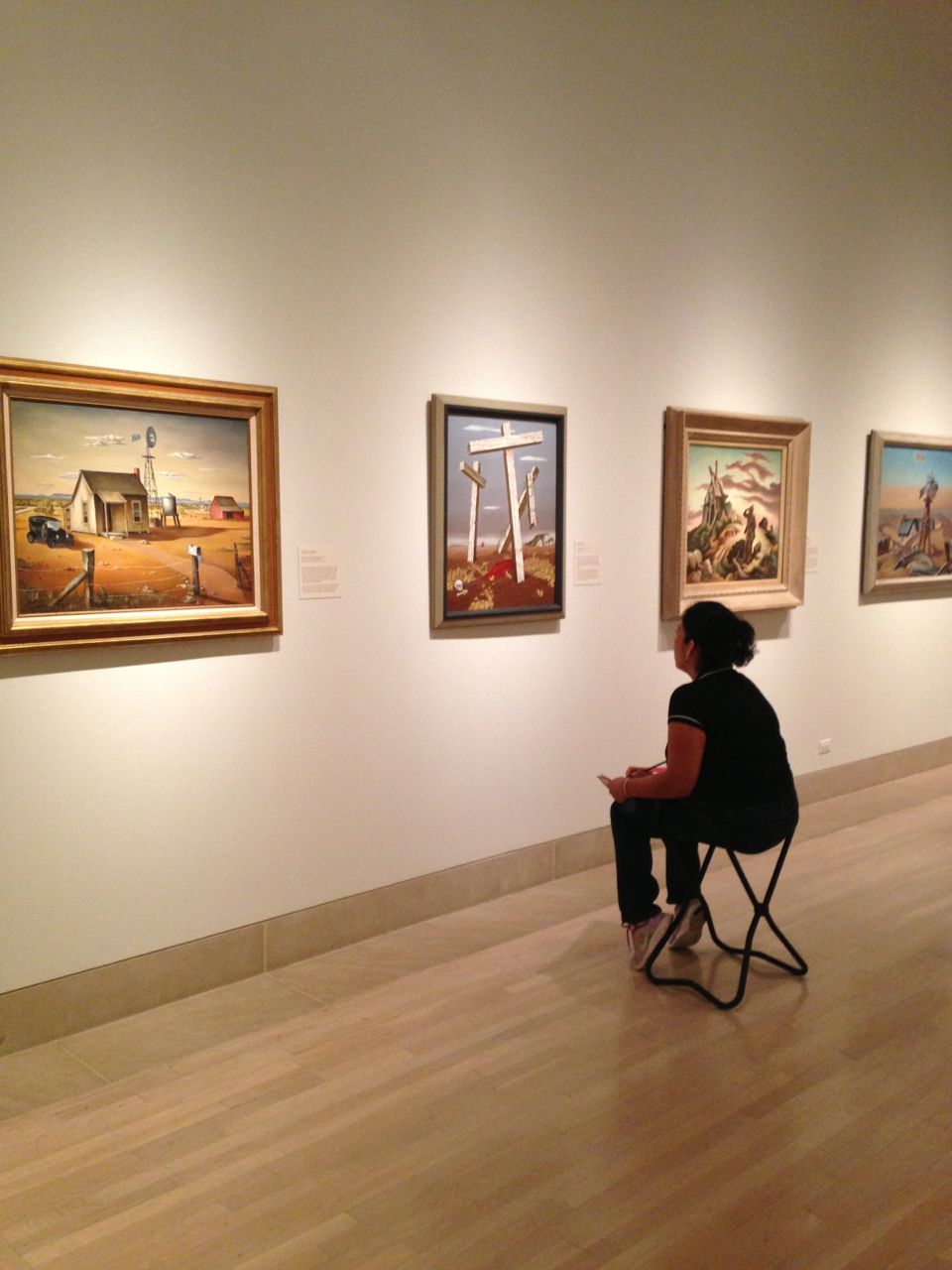 Bety contemplates a 20th-century American painting she has selected for the tour.
