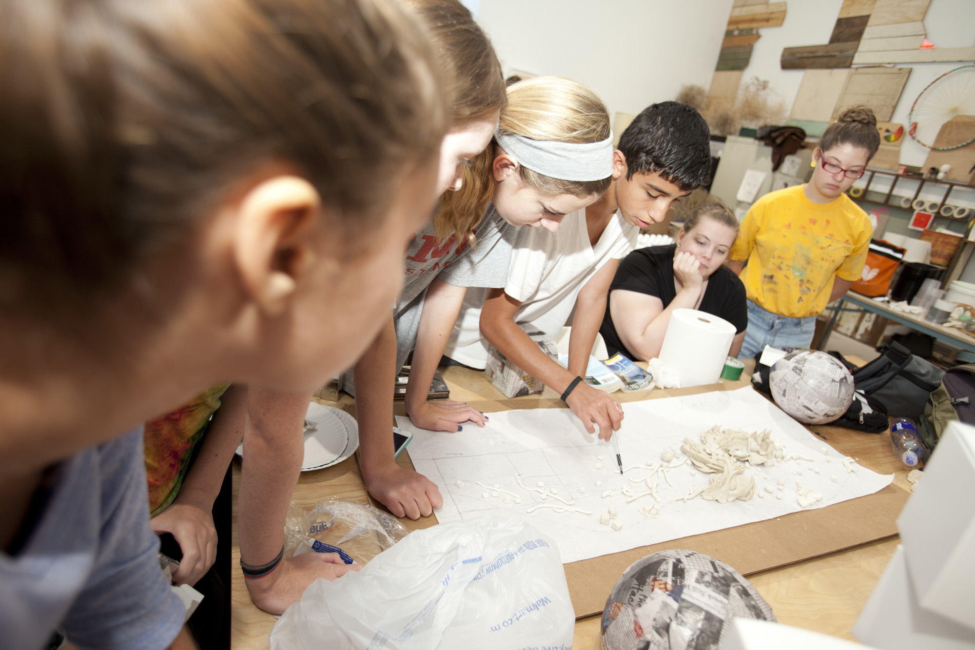 Teen visual artists collaborate on a mural design during the summer 2013 Urban Armor Mural Camp