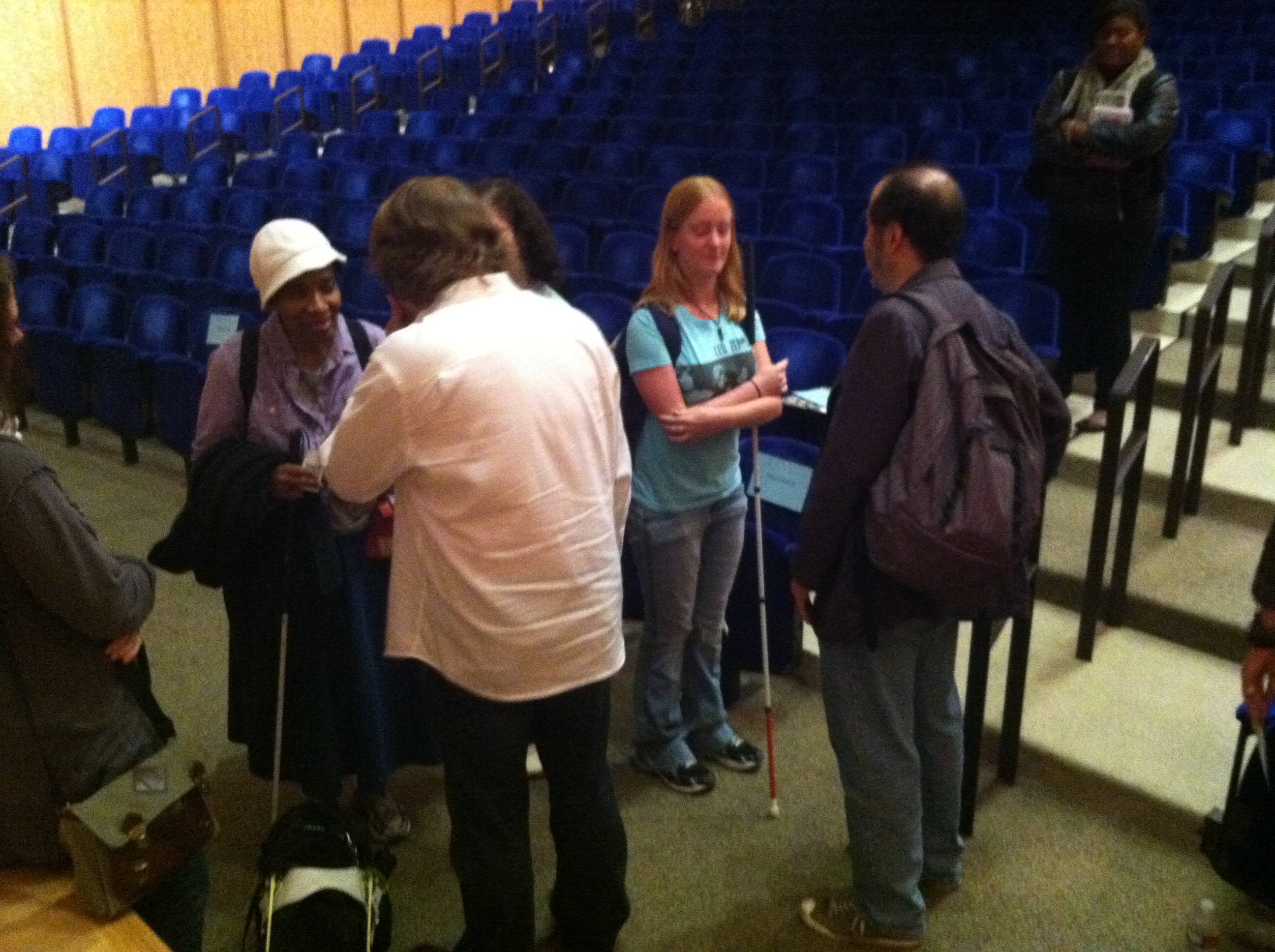 Visitors with vision impairment talking with John Bramblitt and Stephen Lapthisophon after their Late Night artist lecture