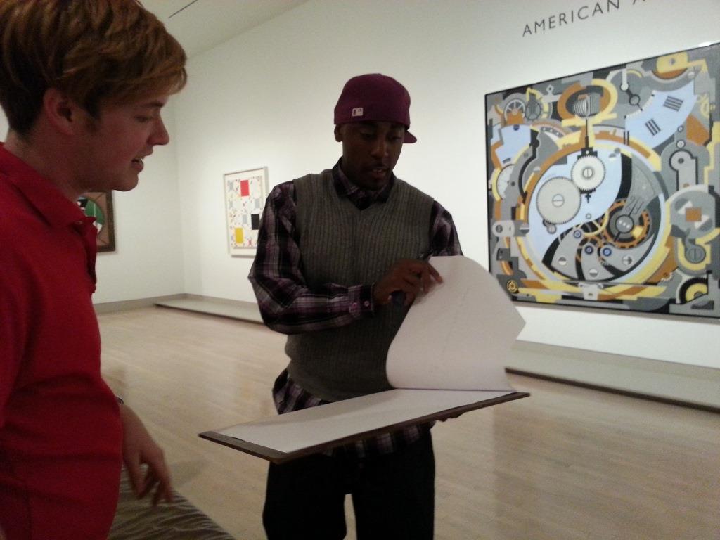 Playing with a visitor and his abstract scribble drawing at the Pop-up Art Spot on level four